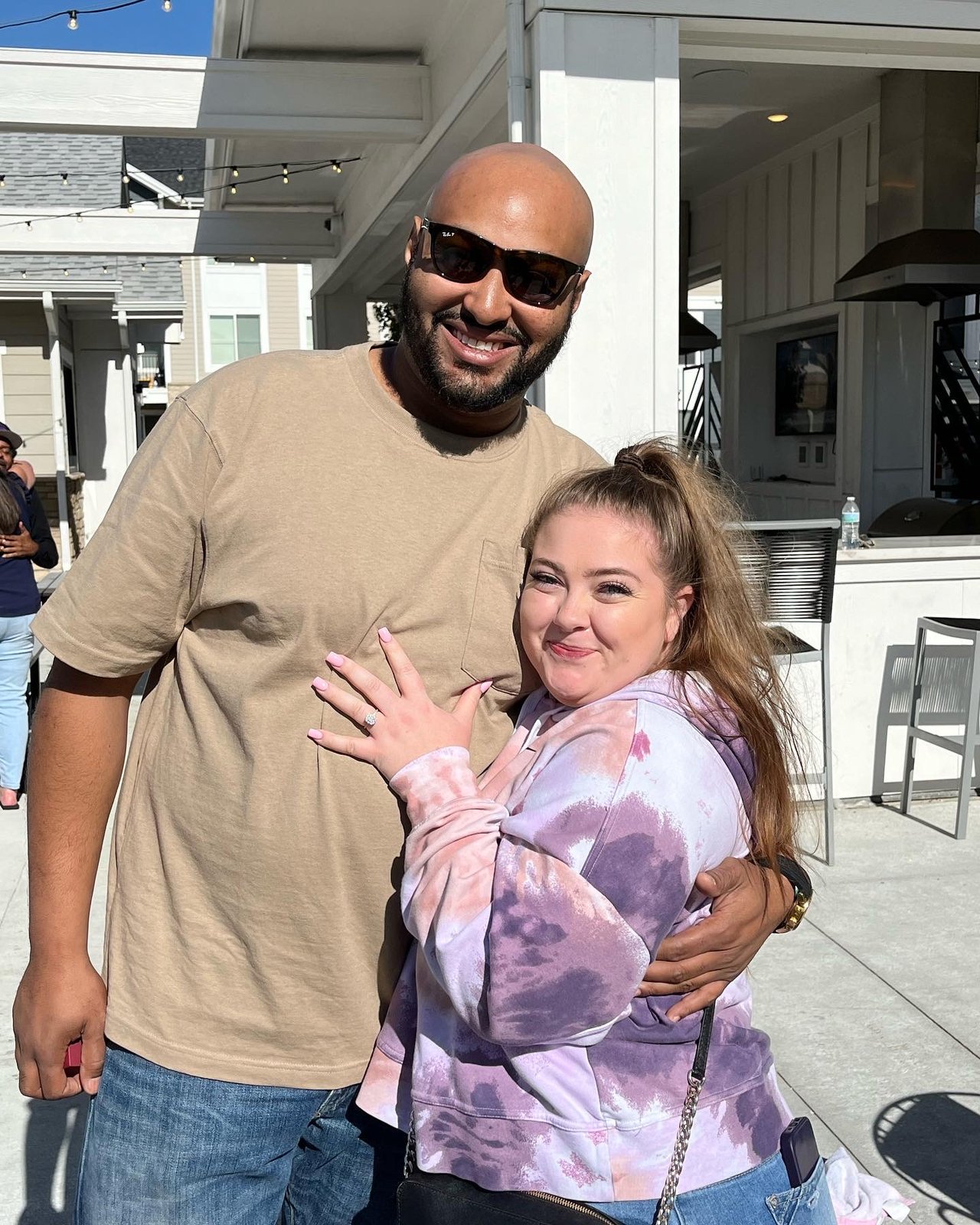 Trevon and Deanna showing engagement ring